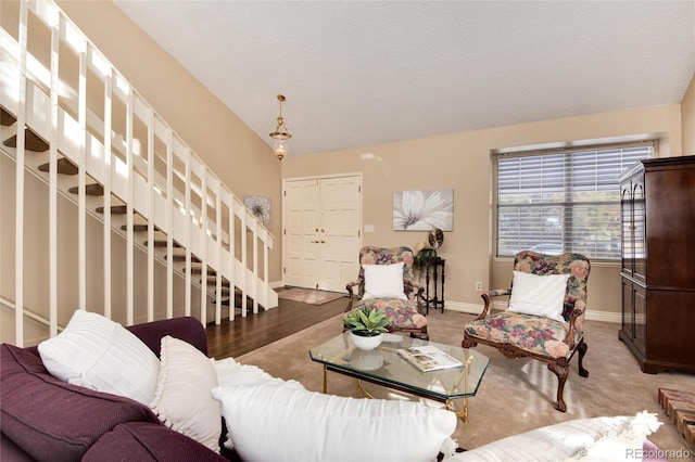 living room with carpet, lofted ceiling, and a textured ceiling