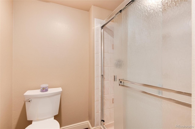 bathroom with walk in shower and toilet