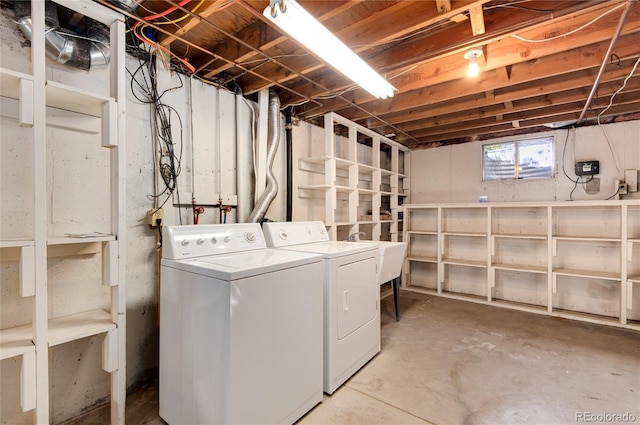 clothes washing area featuring washing machine and dryer and sink