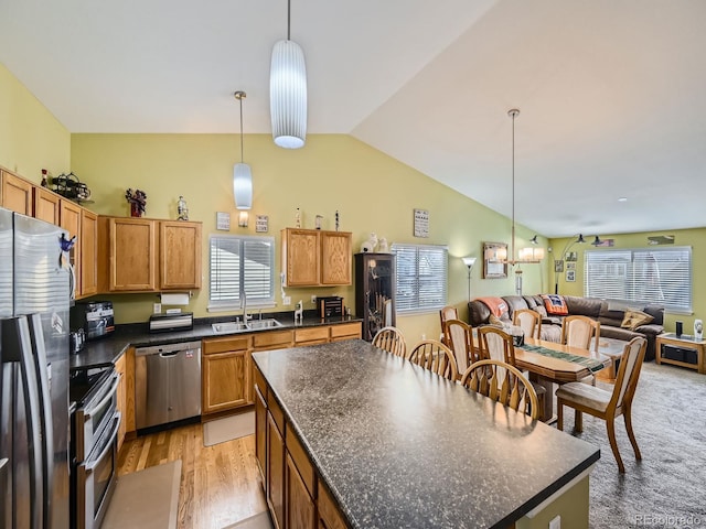 kitchen featuring a wealth of natural light, sink, appliances with stainless steel finishes, and pendant lighting