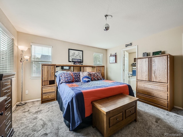 carpeted bedroom with ensuite bath