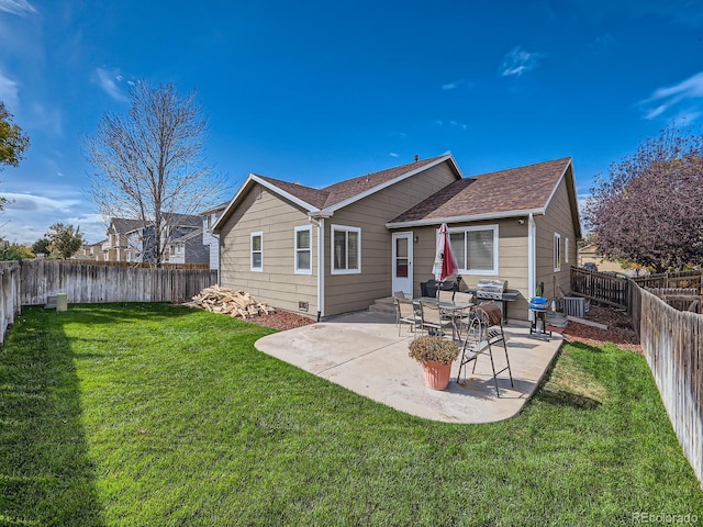 rear view of property featuring a yard and a patio area