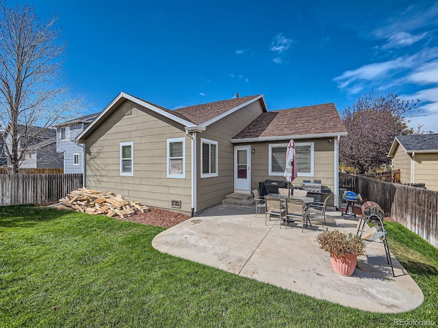 rear view of house featuring a yard and a patio area