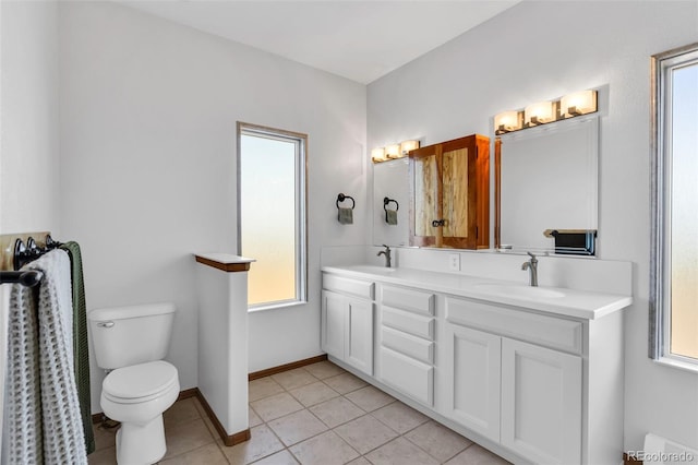 bathroom featuring toilet, vanity, and tile patterned floors