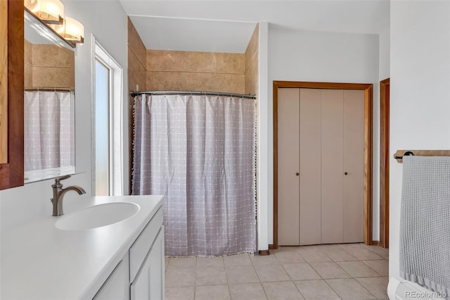 bathroom with tile patterned flooring, a shower with curtain, and vanity