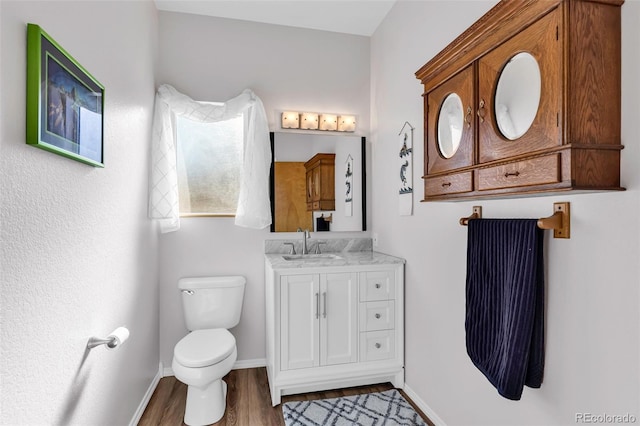 bathroom featuring hardwood / wood-style floors, vanity, and toilet