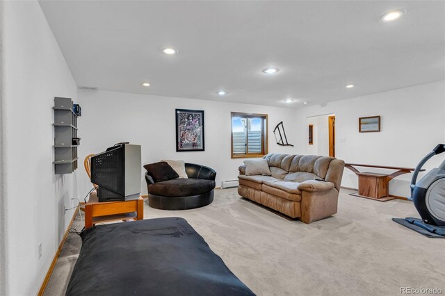 carpeted living room featuring baseboard heating