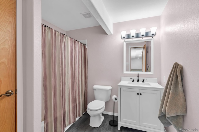 bathroom with hardwood / wood-style floors, vanity, and toilet