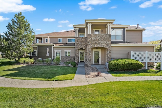 view of front of property with stone siding and a front yard
