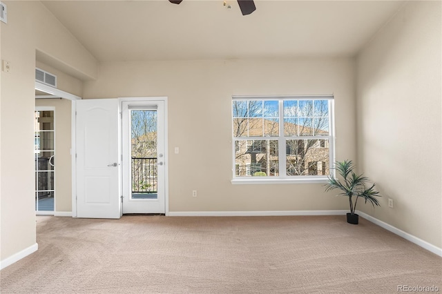 unfurnished room featuring carpet floors, a ceiling fan, healthy amount of natural light, and baseboards