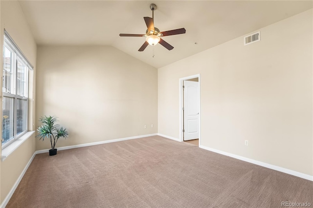 unfurnished room with ceiling fan, carpet floors, lofted ceiling, and baseboards