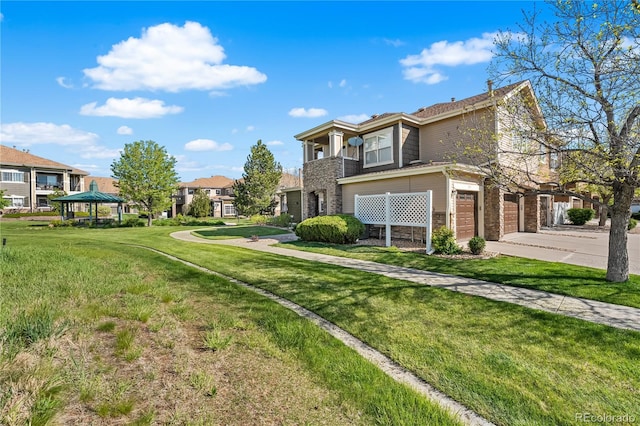 view of property exterior featuring a garage, driveway, a gazebo, and a lawn