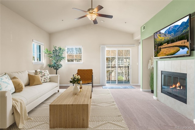 6202 Kilmer Loop Unit 202, Golden, CO 80403 - carpeted living area with a ceiling fan, a tile fireplace, healthy amount of natural light, baseboards, and high vaulted ceiling
