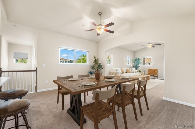 6202 Kilmer Loop Unit 202, Golden, CO 80403 - dining space with a ceiling fan, vaulted ceiling, baseboards, light colored carpet, and arched walkways