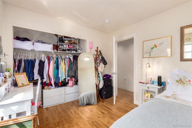 bedroom featuring hardwood / wood-style flooring and a closet