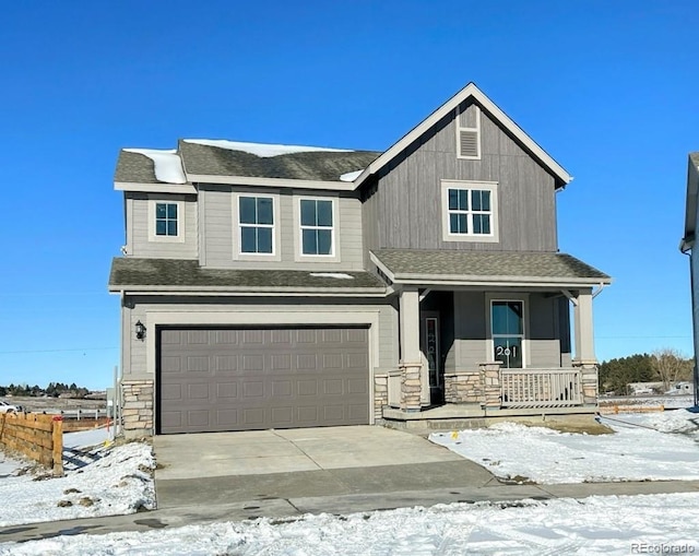 craftsman-style house featuring covered porch, a shingled roof, concrete driveway, a garage, and stone siding