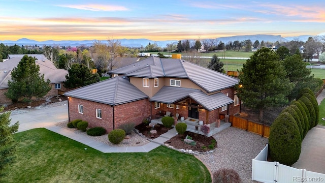 5925 Zinnia Ct, Arvada, CO 80004 - view of front of property featuring a porch, a mountain view, concrete driveway, and a gate