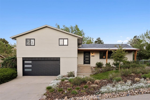 1931 Foothills Rd, Golden, CO 80401 - view of front facade with a garage, brick siding, and concrete driveway