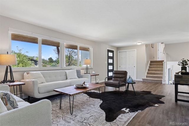 1931 Foothills Rd, Golden, CO 80401 - living area featuring wood finished floors, stairs, baseboards, and a baseboard heating unit
