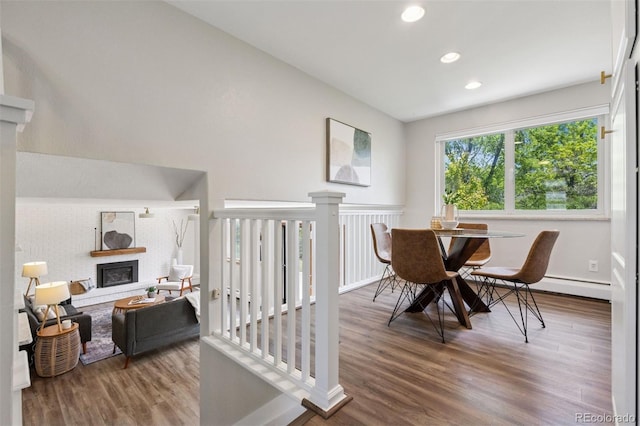 1931 Foothills Rd, Golden, CO 80401 - dining area featuring wood finished floors, a glass covered fireplace, baseboards, and recessed lighting