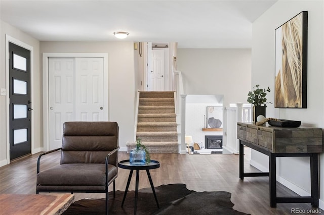 1931 Foothills Rd, Golden, CO 80401 - sitting room featuring wood finished floors, stairs, baseboards, and a glass covered fireplace