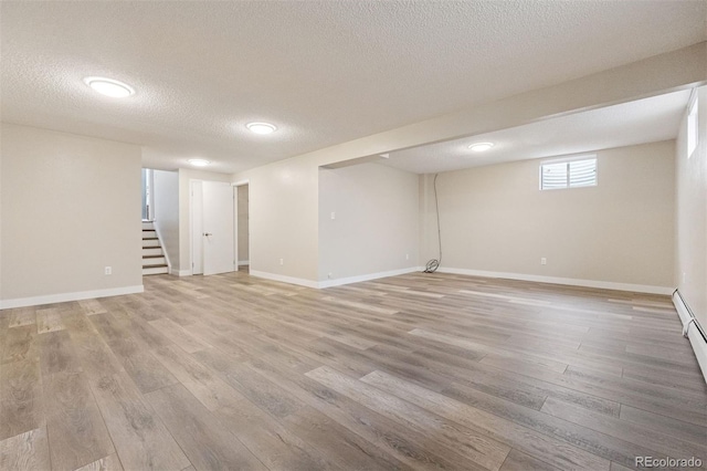 1931 Foothills Rd, Golden, CO 80401 - below grade area with light wood finished floors, a textured ceiling, stairway, and baseboards