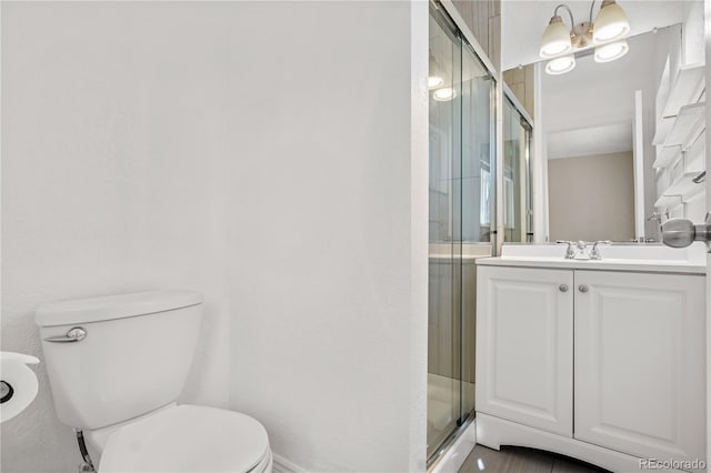 full bath featuring vanity, toilet, and a shower stall