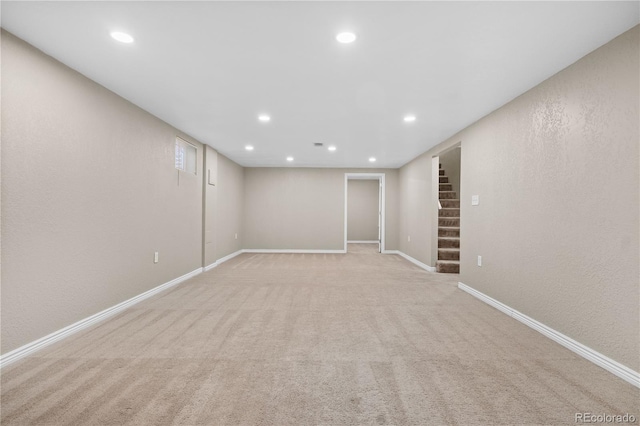 finished basement with recessed lighting, stairway, baseboards, and light carpet