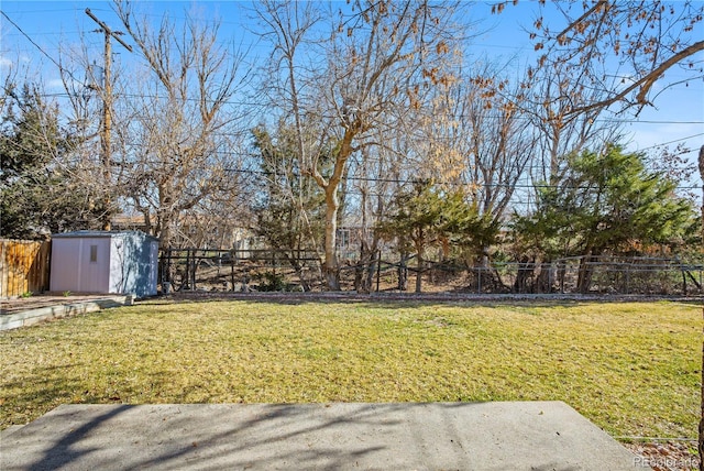 view of yard featuring fence private yard, a storage shed, and an outdoor structure