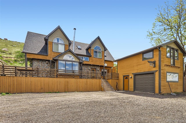 220 Wark Ave, Berthoud, CO 80513 - view of front of home featuring gravel driveway, stairs, an attached garage, and a shingled roof