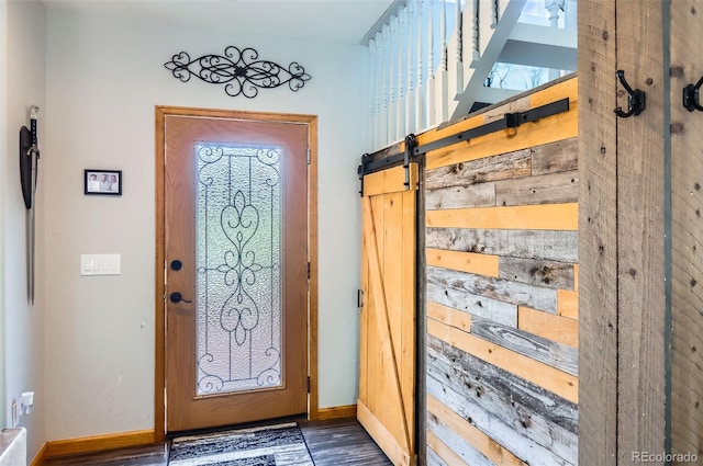 220 Wark Ave, Berthoud, CO 80513 - foyer entrance featuring wood finished floors, a barn door, and baseboards