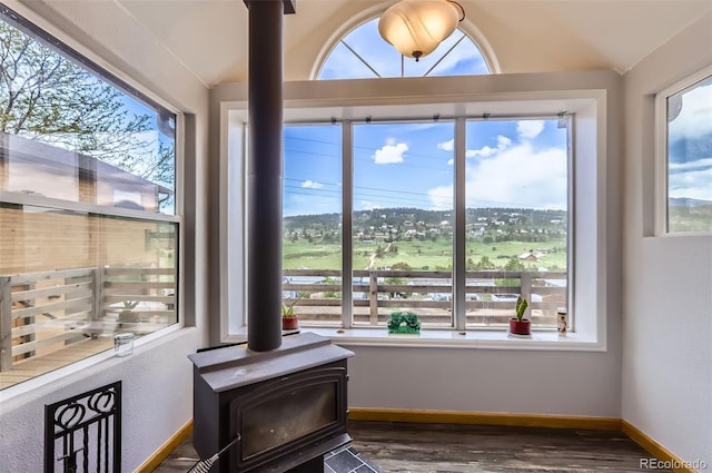 220 Wark Ave, Berthoud, CO 80513 - detailed view of a wood stove, wood finished floors, baseboards, and a golf club