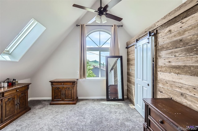 220 Wark Ave, Berthoud, CO 80513 - bonus room with a skylight, wood walls, a barn door, light colored carpet, and lofted ceiling