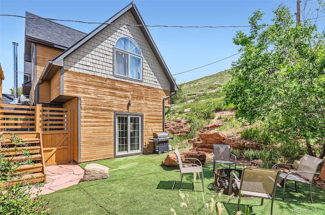 220 Wark Ave, Berthoud, CO 80513 - back of property featuring a lawn and roof with shingles