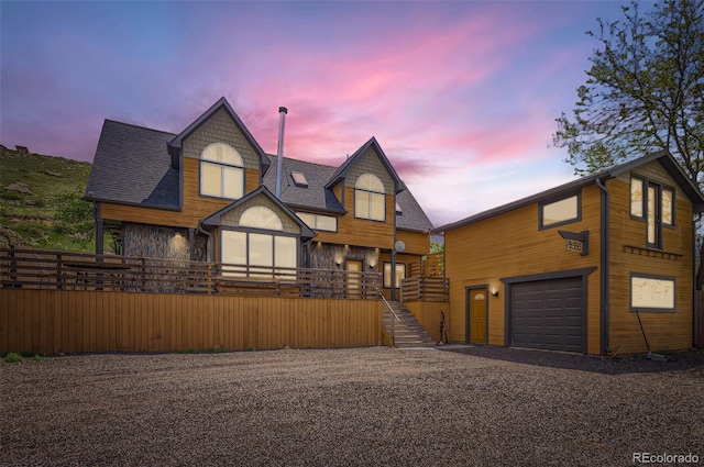 220 Wark Ave, Berthoud, CO 80513 - view of front of property with gravel driveway, stairway, a shingled roof, and a garage