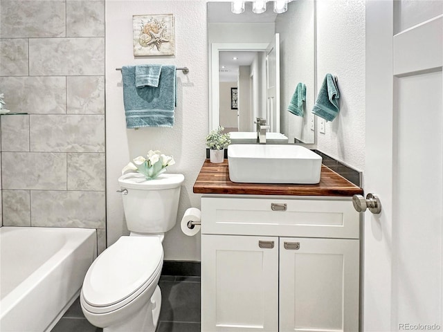 full bathroom with tile patterned flooring, toilet, vanity, and a textured wall