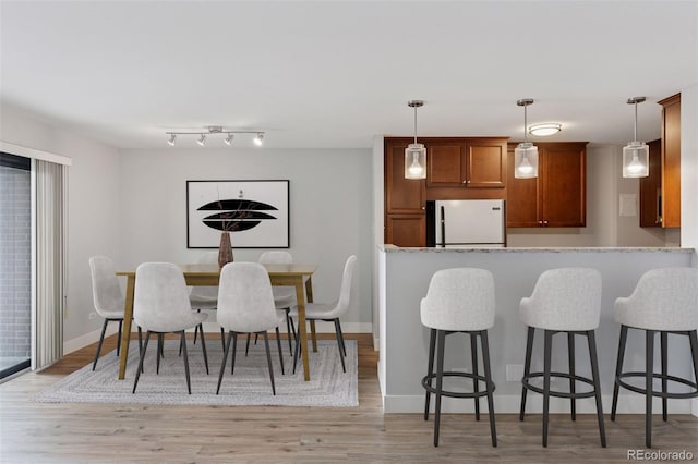 480 S Marion Pkwy Unit 802, Denver, CO 80209 - dining space featuring light wood-style flooring and baseboards