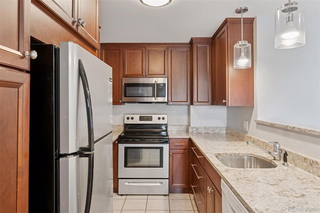 480 S Marion Pkwy Unit 802, Denver, CO 80209 - kitchen featuring appliances with stainless steel finishes, a sink, light tile patterned floors, light stone counters, and hanging light fixtures