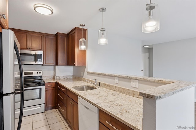 480 S Marion Pkwy Unit 802, Denver, CO 80209 - kitchen featuring stainless steel appliances, a sink, light tile patterned flooring, a peninsula, and light stone countertops