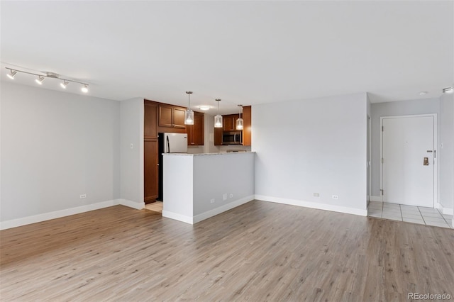 480 S Marion Pkwy Unit 802, Denver, CO 80209 - unfurnished living room with light wood-style flooring and baseboards