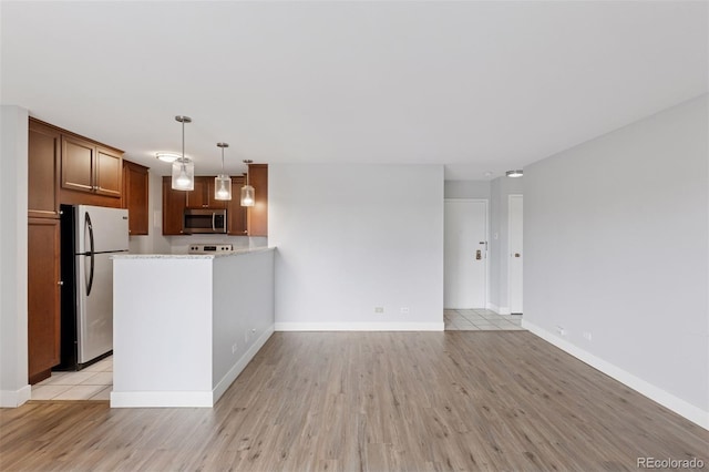 480 S Marion Pkwy Unit 802, Denver, CO 80209 - kitchen with appliances with stainless steel finishes, light wood finished floors, light countertops, and baseboards