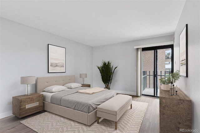 480 S Marion Pkwy Unit 802, Denver, CO 80209 - bedroom featuring access to outside, light wood-style flooring, and baseboards