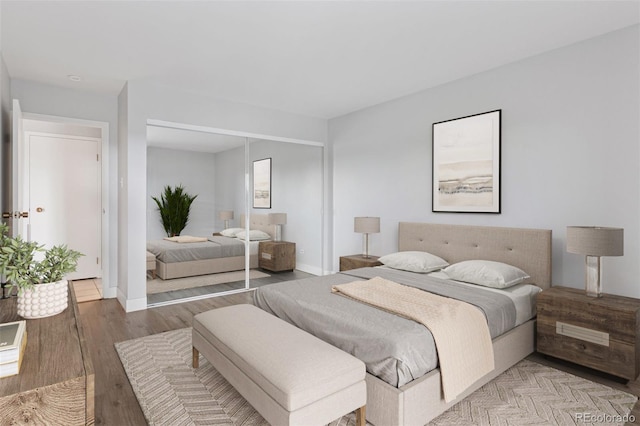 480 S Marion Pkwy Unit 802, Denver, CO 80209 - bedroom featuring wood finished floors, a closet, and baseboards