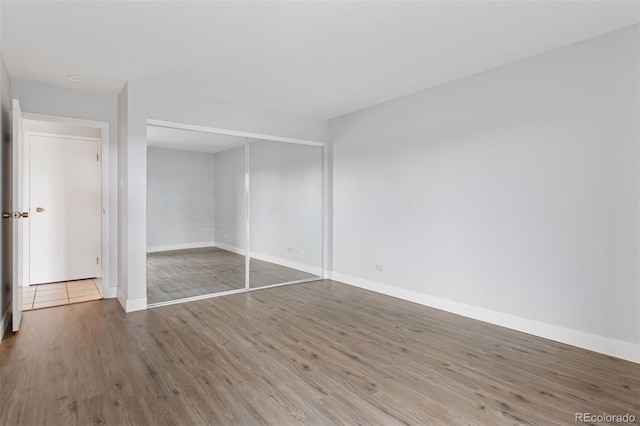 480 S Marion Pkwy Unit 802, Denver, CO 80209 - unfurnished bedroom with wood finished floors, baseboards, and a closet