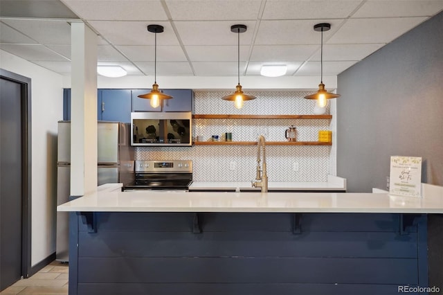 480 S Marion Pkwy Unit 802, Denver, CO 80209 - kitchen with stainless steel appliances, a breakfast bar area, a drop ceiling, light countertops, and hanging light fixtures