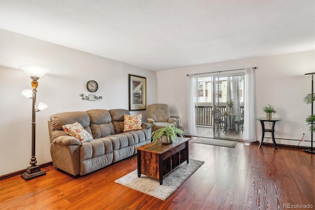3465 S Poplar St Unit 506, Denver, CO 80224 - living room with wood finished floors and a baseboard heating unit