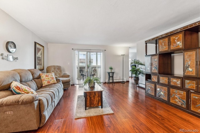 3465 S Poplar St Unit 506, Denver, CO 80224 - living room featuring dark wood-style floors and a baseboard heating unit