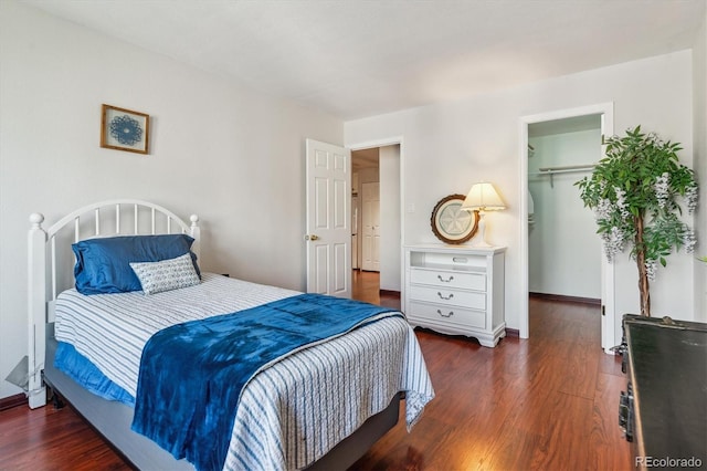 3465 S Poplar St Unit 506, Denver, CO 80224 - bedroom featuring a walk in closet, wood finished floors, and a closet