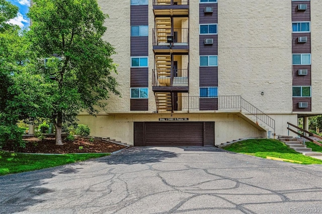 3465 S Poplar St Unit 506, Denver, CO 80224 - view of apartment building / complex featuring driveway, a garage, and stairway