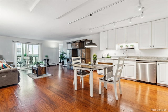 3465 S Poplar St Unit 506, Denver, CO 80224 - kitchen featuring dishwasher, white cabinets, light wood-style flooring, open floor plan, and hanging light fixtures